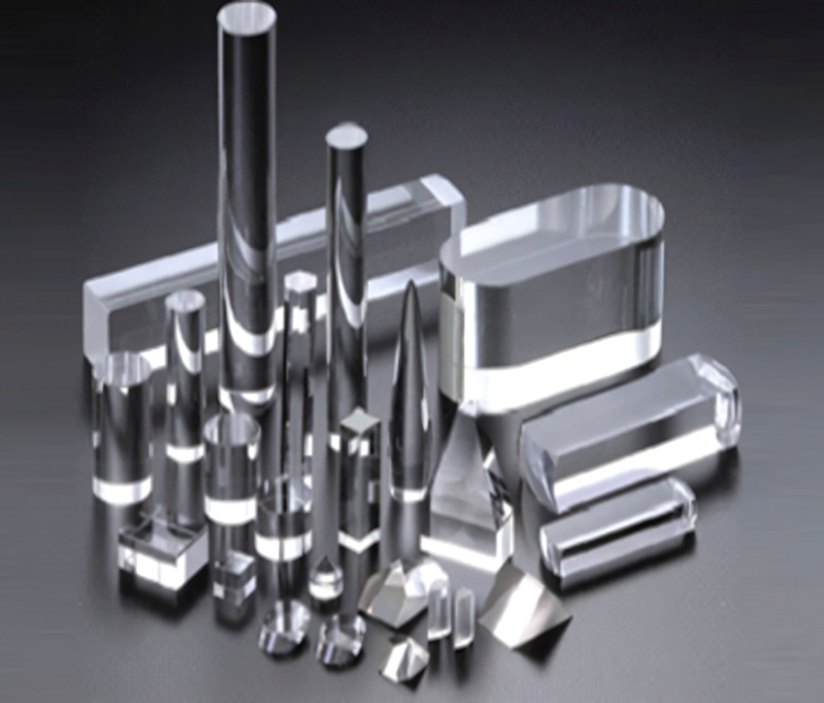 プリズムやレンズ、ロッドなど、様々な形状に精密研磨された光学用ガラス・結晶部品の集合写真